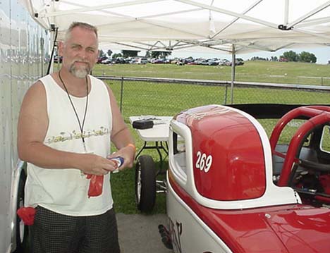 Dave Cox polishes up his immaculate "Hellzapoppin'" Coupe. Dave's car really turned a lot of heads at Bowling Green.