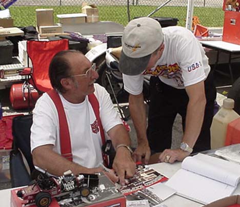 Even World Champion Funny Car racers have heroes! Bruce Larson gets an autograph from Mousie Marcellus.