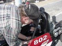 Tom Putnam straps Jason into the car and fixes his helmet. Photo by Denise Pratt