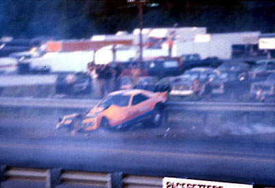 His front end smashed, Al bounces off the guardrail and gets control. Photo by James Morgan