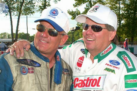 The boss (John Force) congratulates Gary Densham.