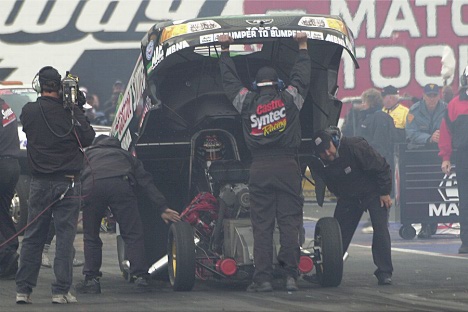 A final adjustment to Tony Pedregon's funny car.