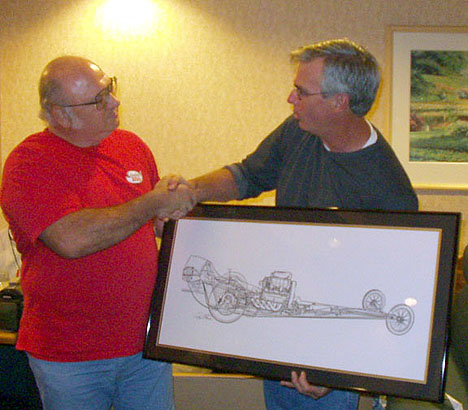 Tom West presents Bill Pitts with an autographed see-through drawing of his restored Magicar. Photo by Phil Elliott