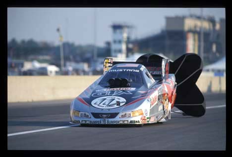 John Force pulls the chutes at Indy 2002. Photo by Ron Lewis