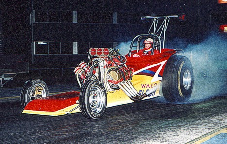 Eddie McDow burns some rubber in his awesome Texas altered. Photo by Chris Graves