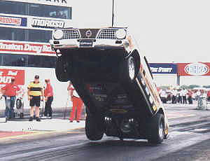 The Hemi Under Glass gets all four wheels off the ground at Indy. Photo by Tony Neu