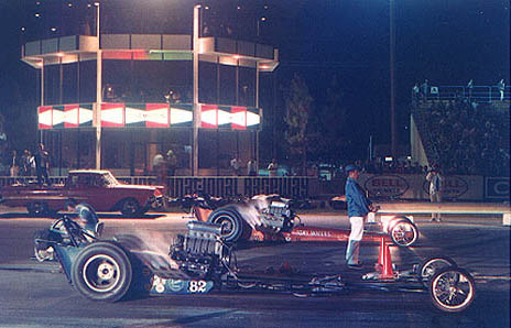 A truly beautiful sight -- two fuelers with the fuses lit under the lights. Photo thanks to Drag Racing Memories