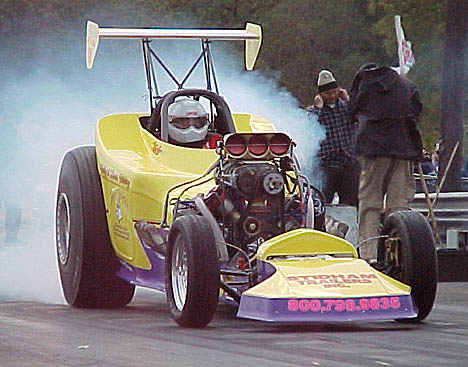 Wild Bill Howry hammers it at Texas Raceway as two Bob and Doug McKenzie look-alikes take cover. Photo by Chris Graves