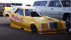 Was the Lincoln Mark IV high class? They used a "French Maid" (with appropriate costume) to feather dust the car in the pits and back it up on burnouts! Photo by David Ray