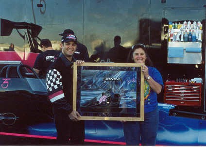 Laurie Watts presents Tony Schumacher with a stained glass picture of the Exide Top Fueler. Photo thanks to Laurie Watts