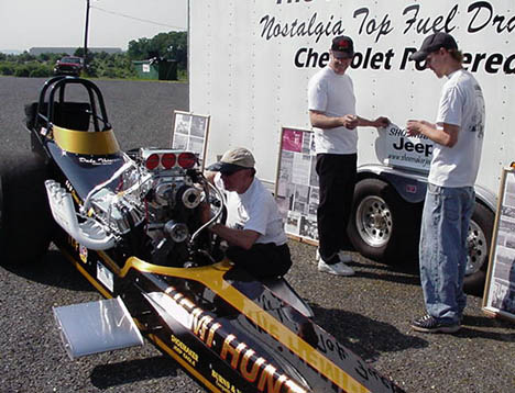 Gary Peters working on the Hemi Hunter even at the show. Dale and Adam Thierer look on. Photo by the HH Team