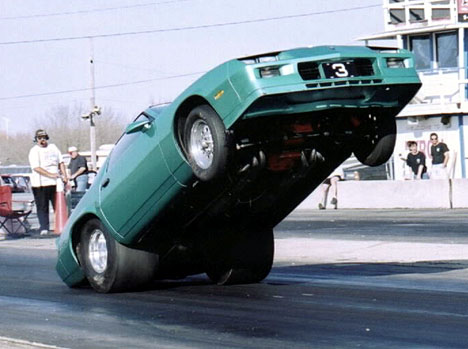 Joe Priola gets WAY up on the back bumper. Photo by Rick Kurtz