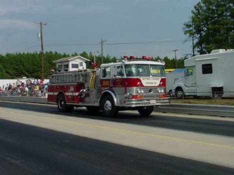 What looks like a parade down the track is actually the local VFD rushing to the seen of a grass fire that ignited when a racer blew a motor and pulled off the return road. Roger Richards photo