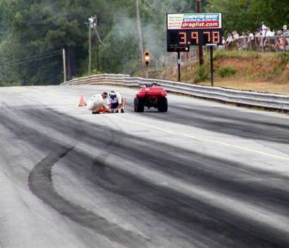 This photo tells many tales. Rick Murry's tire tracks shows his shaking and following Todd Bauknecht through the lights after Todd reset the brand new track records. Hey, I like that new scoreboard! Brian Wood photo