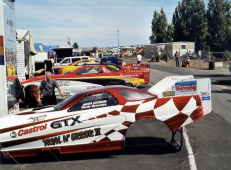 Nitro Funny Car pit row with Jason Duchene, Jack Wyatt, and the Impulse. Photo by David Hapgood